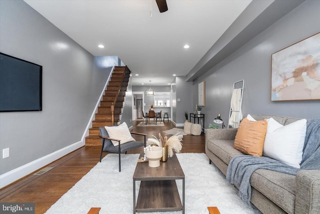 living area with stairway, recessed lighting, wood finished floors, and baseboards