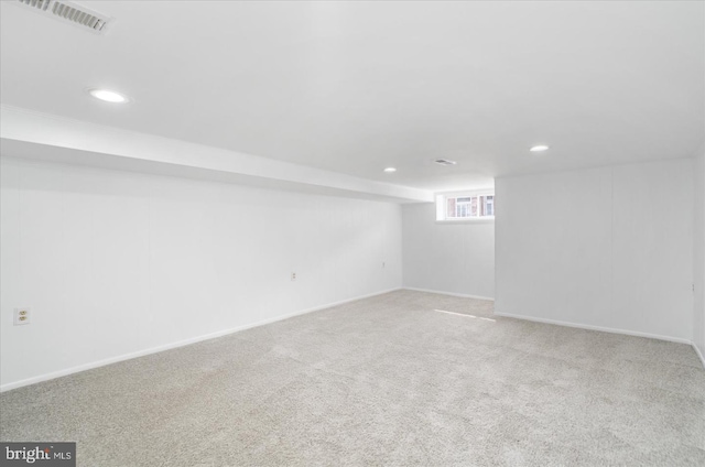 below grade area with carpet floors, recessed lighting, visible vents, and baseboards