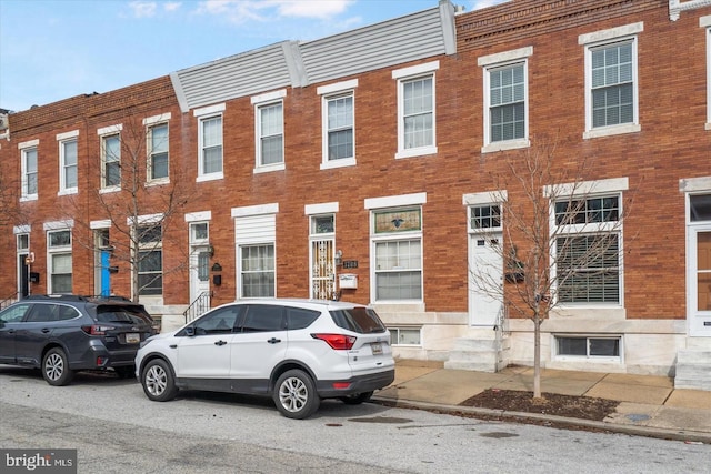 multi unit property featuring entry steps and brick siding