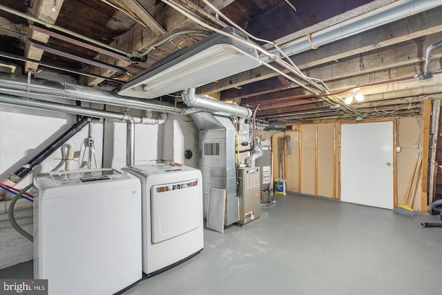 unfinished below grade area with visible vents and washer and clothes dryer