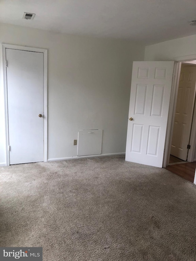 interior space featuring carpet floors and visible vents