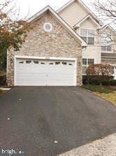 view of front of property with a garage and aphalt driveway