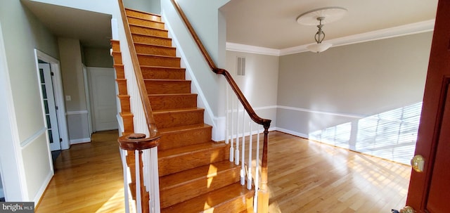 20153 Valhalla Sq, Ashburn, VA 20147 - staircase with wood finished floors, crown molding, baseboards, and visible vents