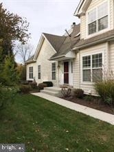 rear view of property featuring a lawn