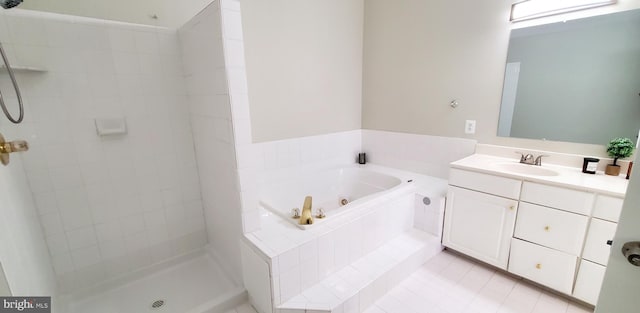20153 Valhalla Sq, Ashburn, VA 20147 - bathroom with tile patterned flooring, vanity, a whirlpool tub, and tiled shower