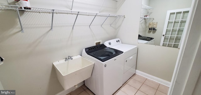 20153 Valhalla Sq, Ashburn, VA 20147 - laundry area with light tile patterned flooring, separate washer and dryer, laundry area, and a sink