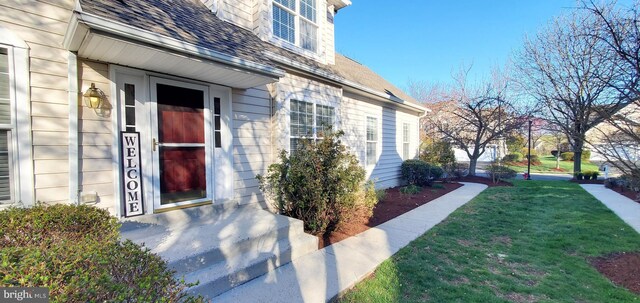 20153 Valhalla Sq, Ashburn, VA 20147 - view of exterior entry with a lawn and a shingled roof