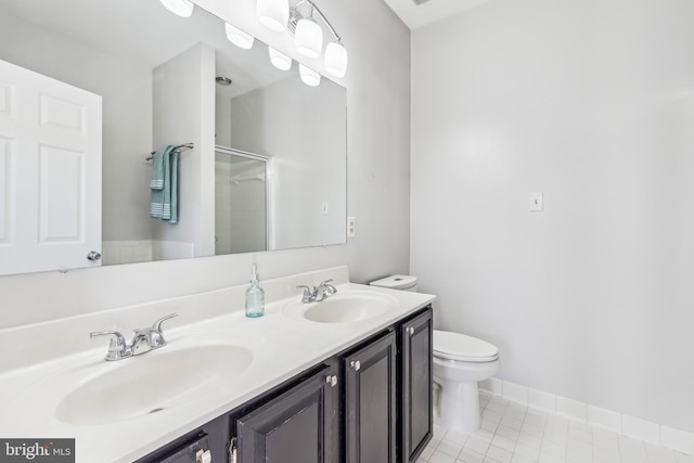 bathroom featuring a shower with shower door, tile patterned flooring, a sink, and toilet