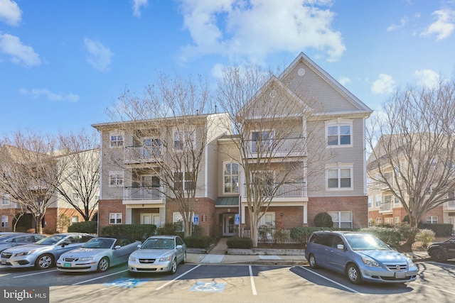 view of building exterior with uncovered parking