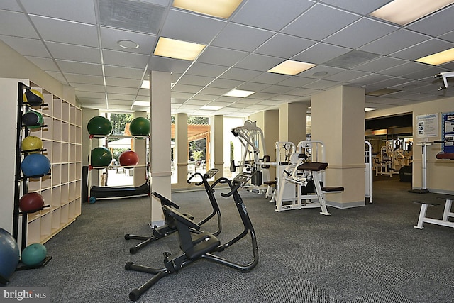 exercise room with a drop ceiling and visible vents