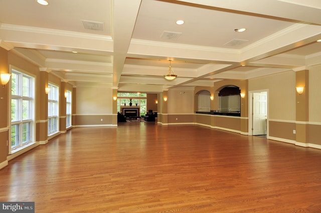 unfurnished living room with coffered ceiling, a fireplace, wood finished floors, baseboards, and beam ceiling