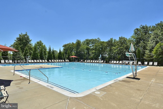 pool featuring fence and a patio