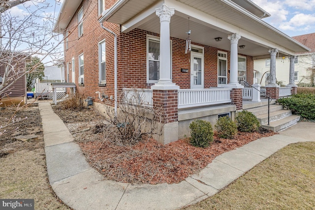 bungalow with brick siding and a porch