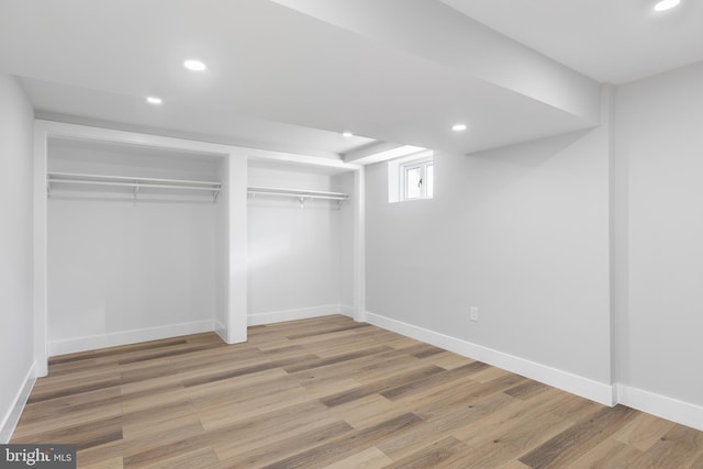 below grade area with baseboards, wood finished floors, and recessed lighting