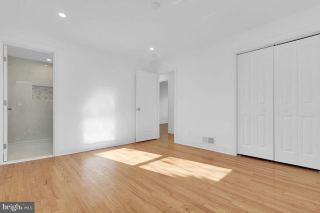 unfurnished bedroom featuring visible vents, wood finished floors, recessed lighting, a closet, and baseboards