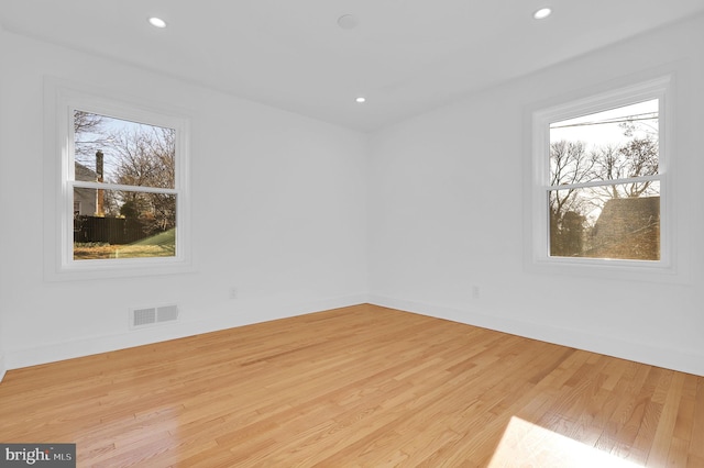 spare room featuring recessed lighting, visible vents, baseboards, and light wood finished floors