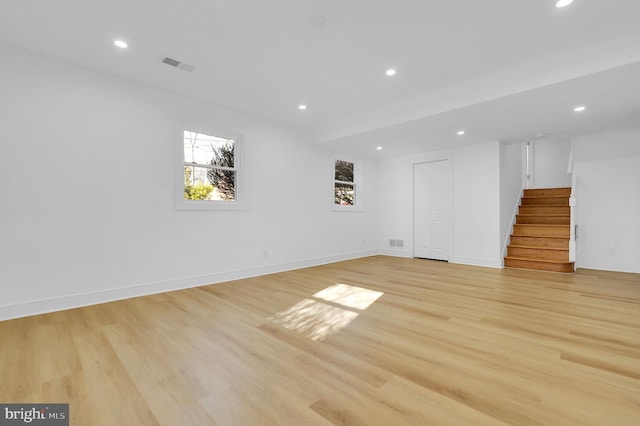 spare room with visible vents, recessed lighting, stairway, light wood-style floors, and baseboards