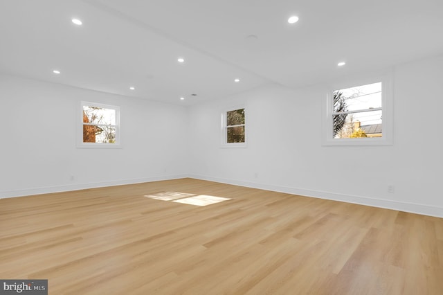 empty room with recessed lighting, light wood-style floors, and a healthy amount of sunlight