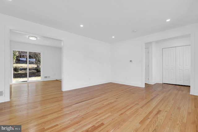 unfurnished living room with recessed lighting, light wood-style flooring, visible vents, and baseboards