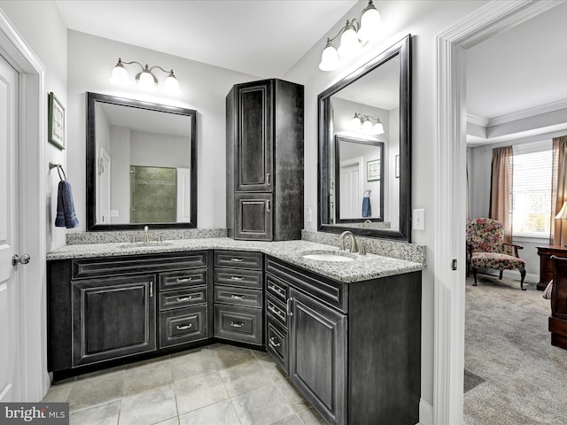 bathroom with double vanity, ornamental molding, a sink, and tile patterned floors