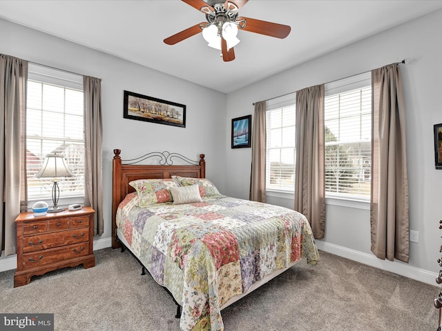 carpeted bedroom with a ceiling fan and baseboards