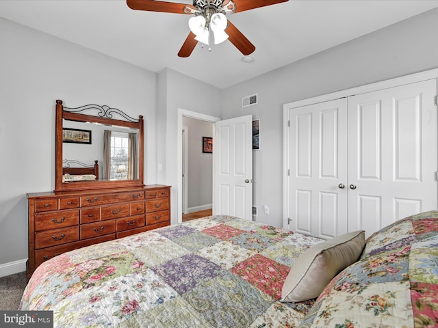 bedroom with a closet, visible vents, a ceiling fan, carpet flooring, and baseboards