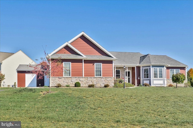 craftsman-style home featuring stone siding and a front yard