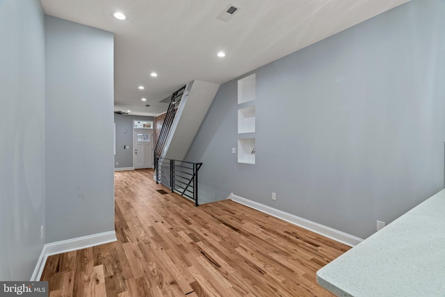 interior space with light wood-style floors, recessed lighting, visible vents, and baseboards