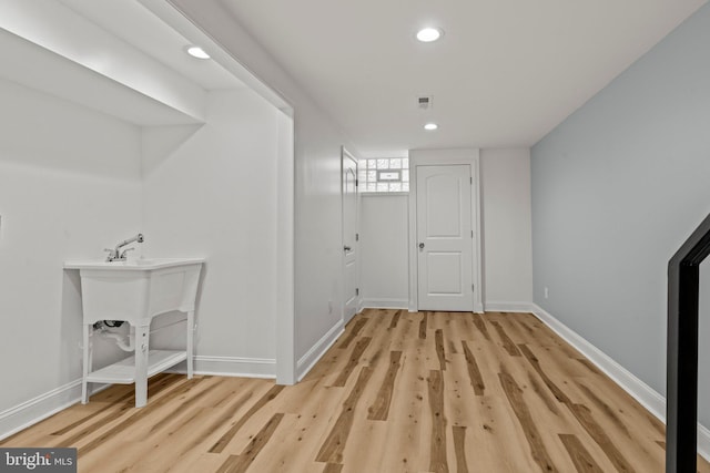 interior space with light wood-type flooring, baseboards, and recessed lighting