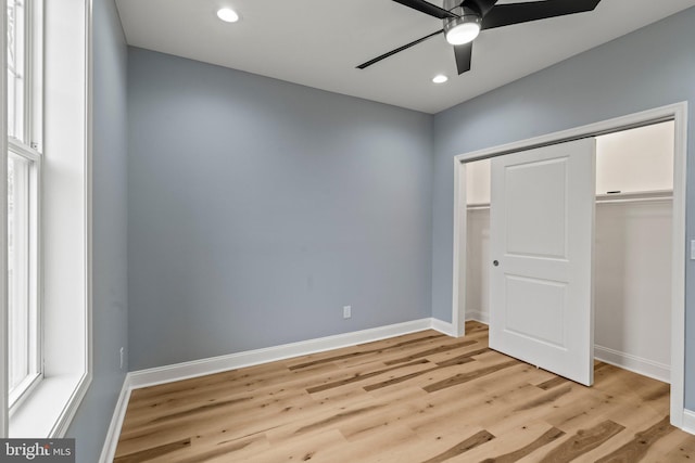 unfurnished bedroom with light wood finished floors, a closet, and baseboards