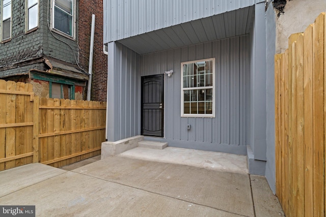 doorway to property featuring fence