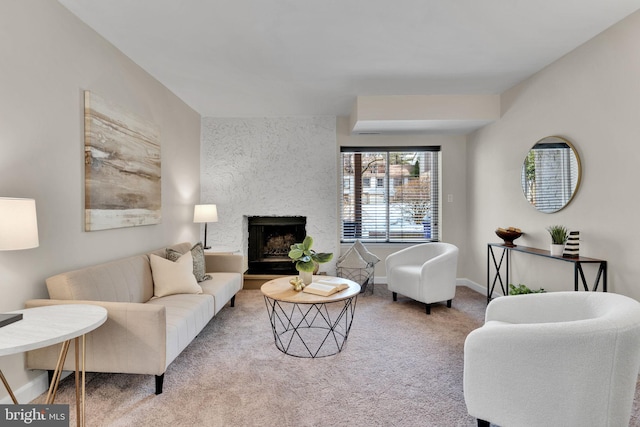 carpeted living room with a fireplace and baseboards