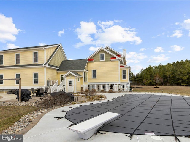 back of house featuring a patio and a chimney