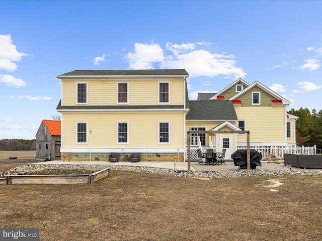 rear view of property with a patio area and fence