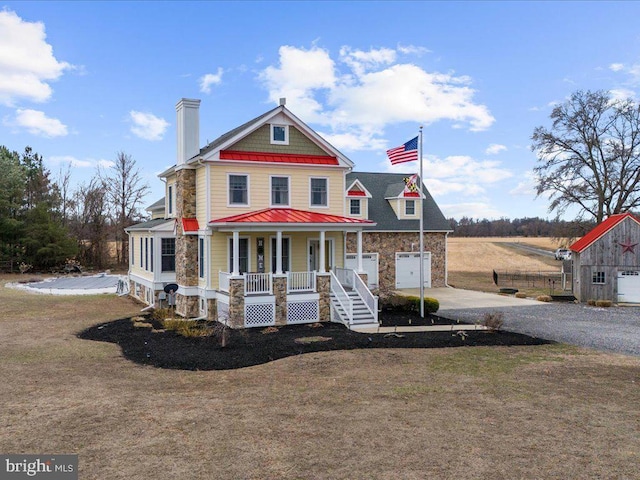 view of front of house featuring a porch, concrete driveway, and stone siding