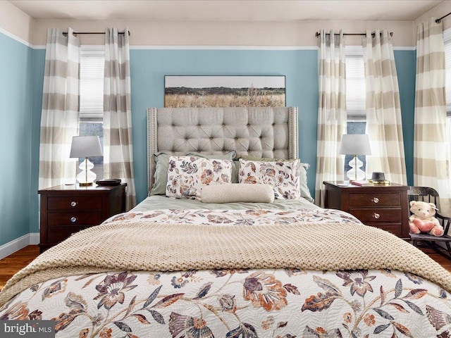 bedroom featuring wood finished floors and baseboards