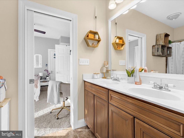 full bathroom featuring double vanity, a sink, and ensuite bathroom