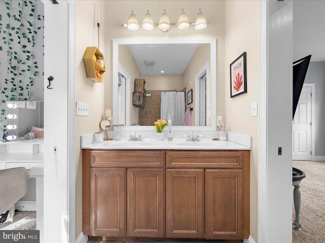 bathroom featuring double vanity, a shower with shower curtain, and a sink