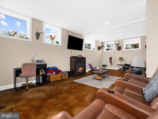 living area with recessed lighting, baseboards, and a glass covered fireplace