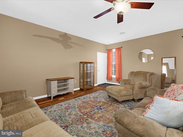 living area with plenty of natural light, a ceiling fan, and wood finished floors