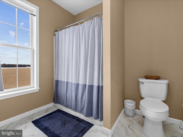 full bath with a shower with shower curtain, toilet, and baseboards