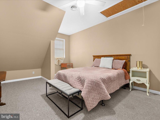 carpeted bedroom featuring visible vents, vaulted ceiling, baseboards, and ceiling fan