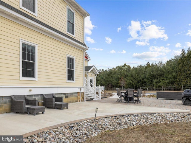 view of patio / terrace with entry steps and fence