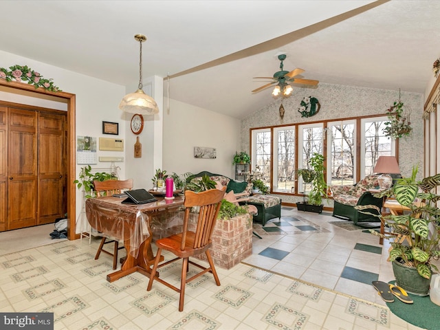 dining space with a ceiling fan and vaulted ceiling