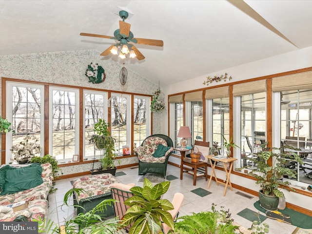 sunroom / solarium with lofted ceiling, ceiling fan, and visible vents