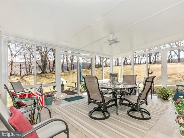 sunroom / solarium featuring a ceiling fan