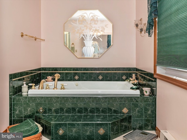 bathroom with a baseboard heating unit and a bath