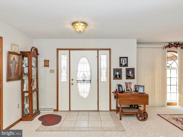 entrance foyer featuring visible vents, baseboards, and light tile patterned flooring