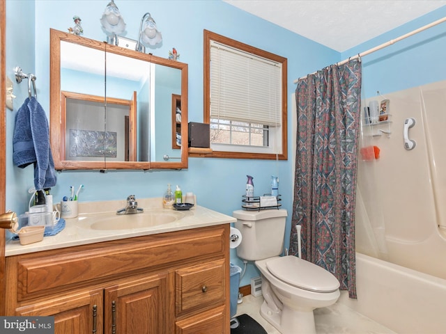 bathroom featuring toilet, shower / bath combo with shower curtain, and vanity