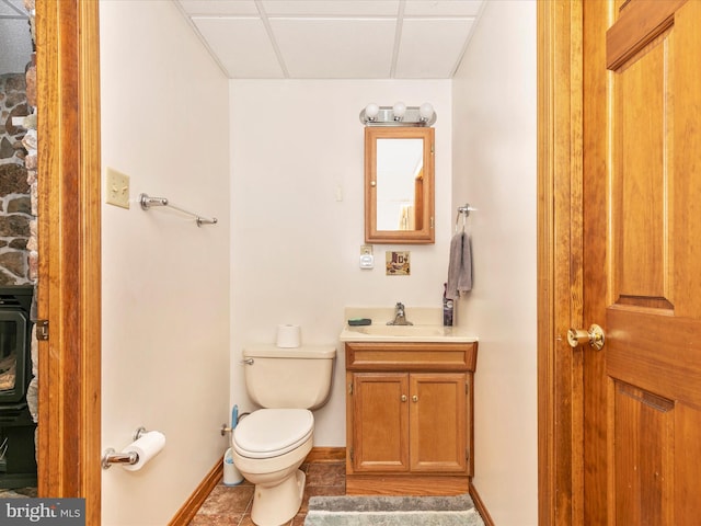 bathroom with toilet, vanity, baseboards, and tile patterned floors